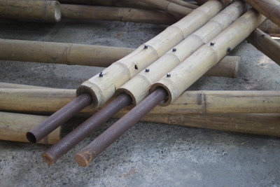 Rectangular pond divided by bamboo sticks and fenced with bamboo pole